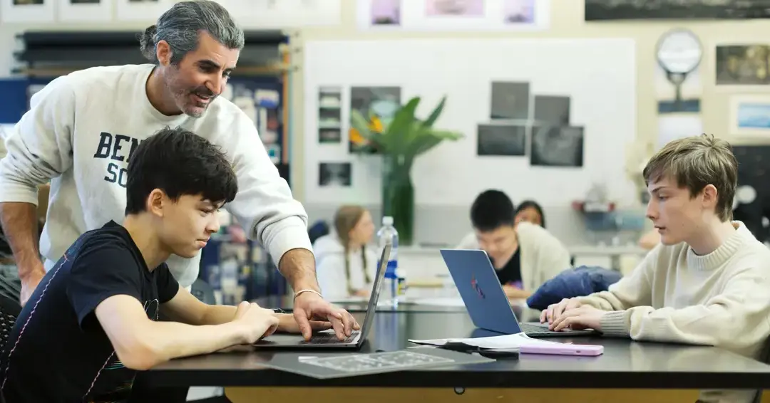 Teacher helping student during class