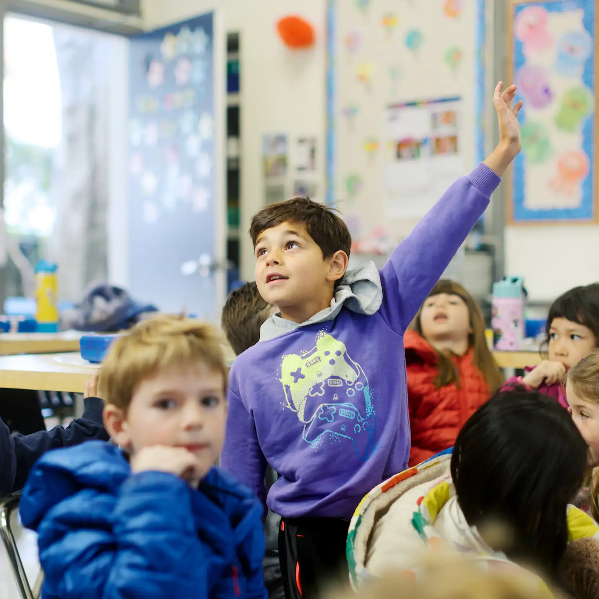 Student raising hand in class