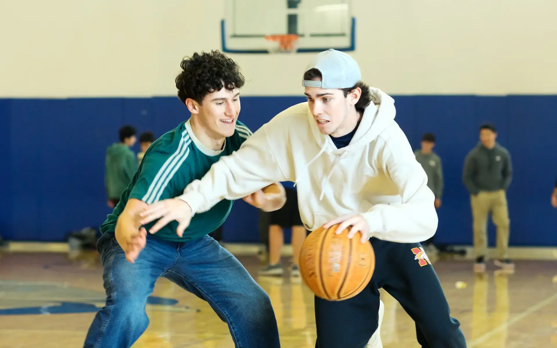 Two Upper School boys playing basketball in the Gym. 