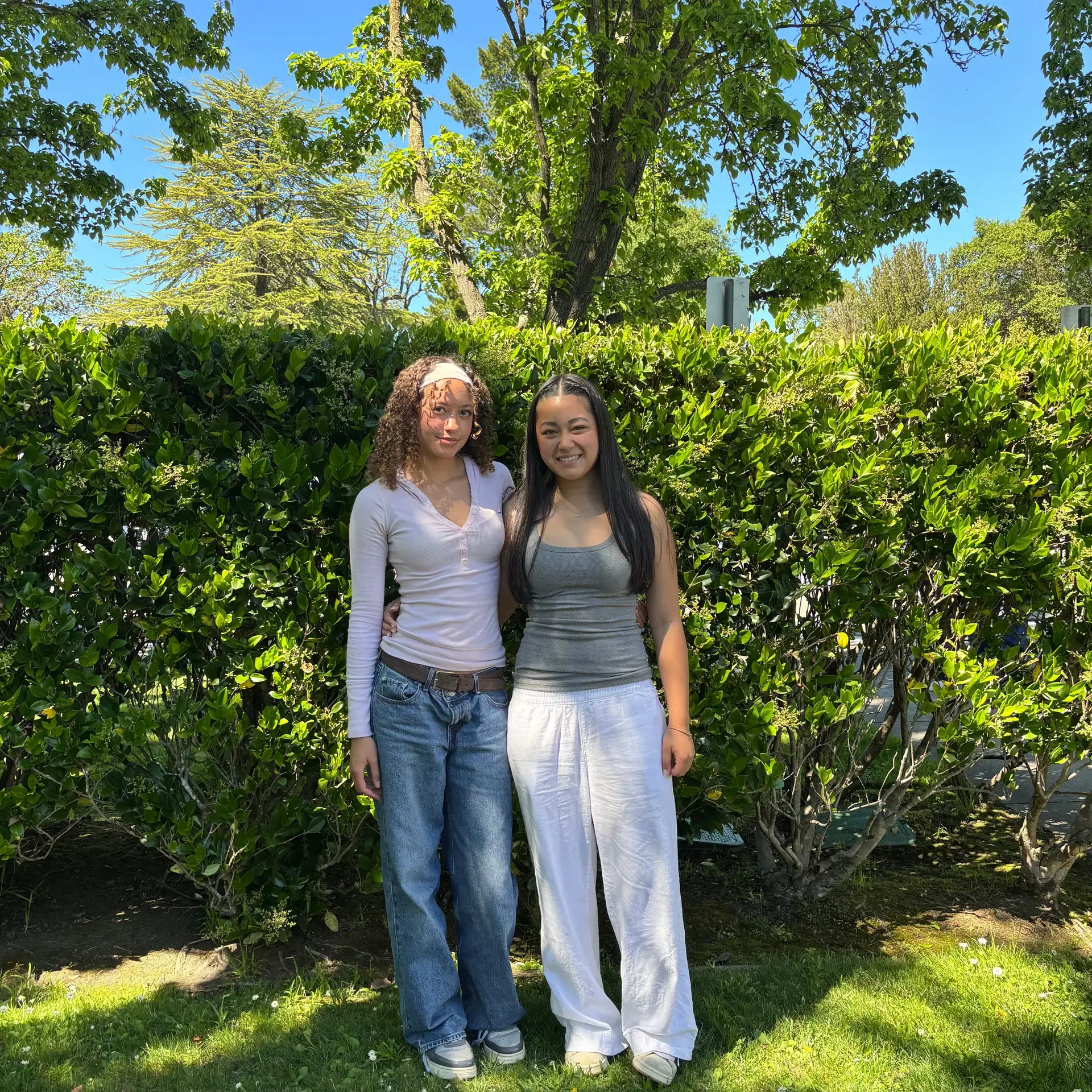 Two Upper School girls standing outside in the Grove.