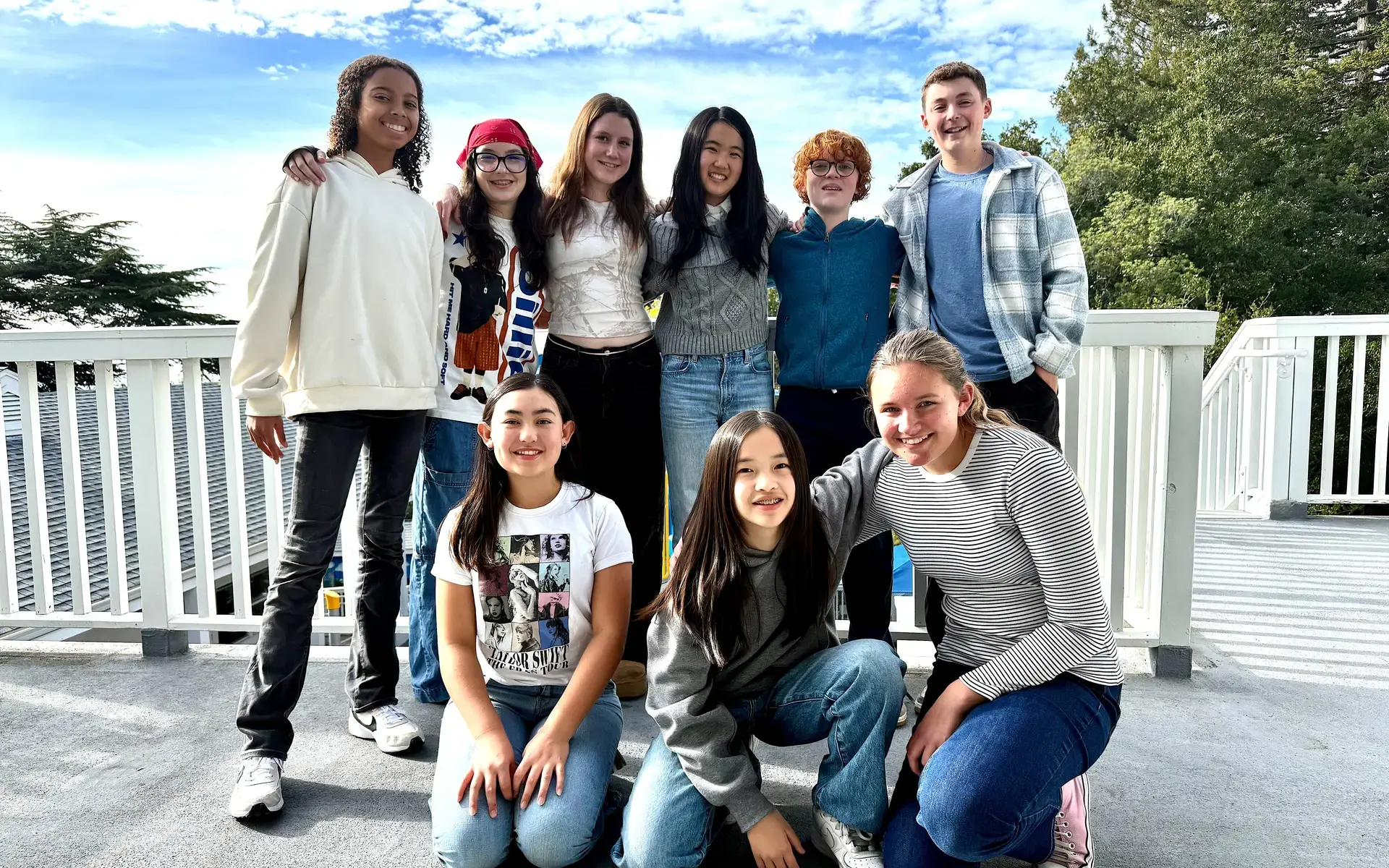 Middle School Student Council officers pose for a candid photo on a balcony.
