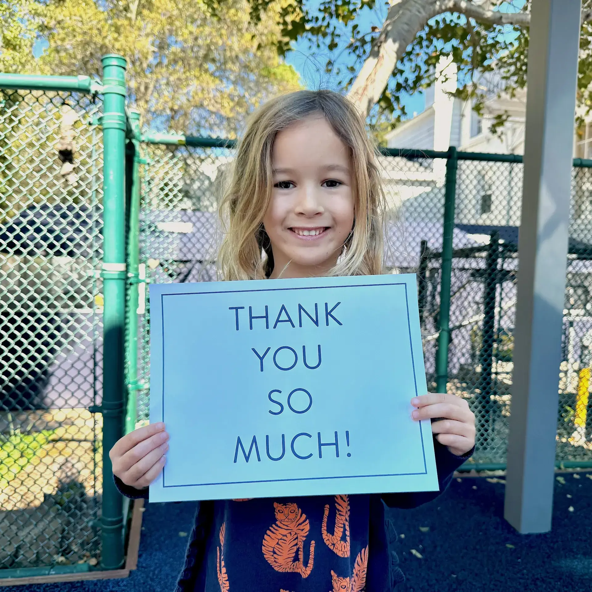 Student holding up thank you sign