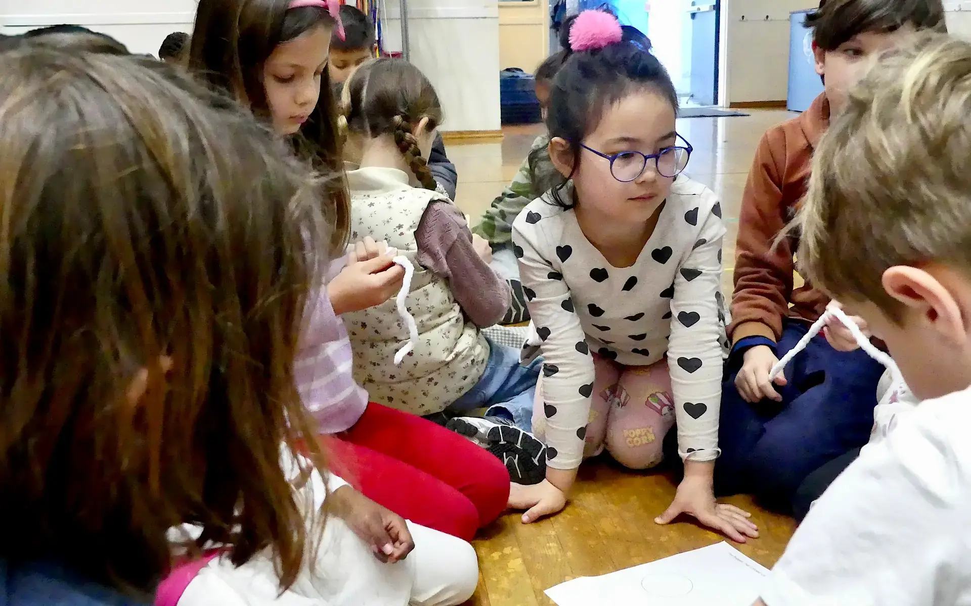  group of Lower School students  gathers to brainstorm together in Meadows Auditorium.