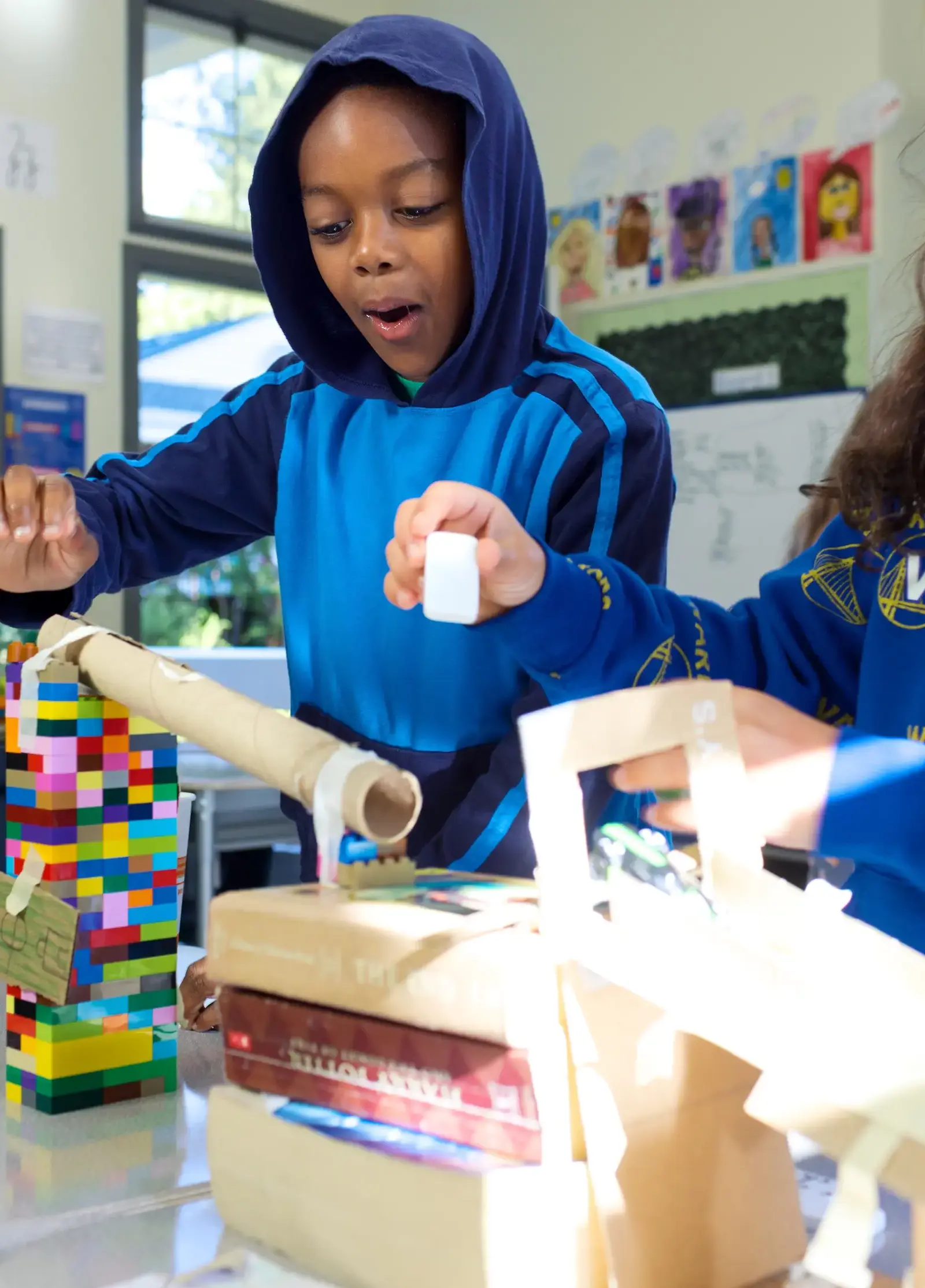 Lower School students work on simple machines together in the classroom. 