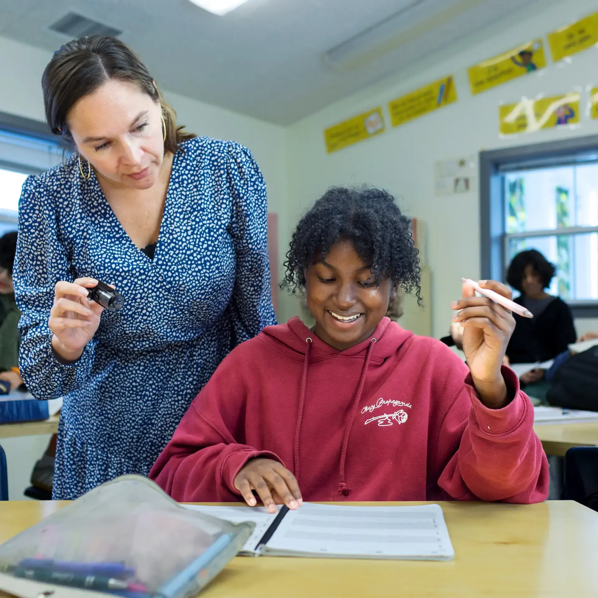 Teacher helping student in class