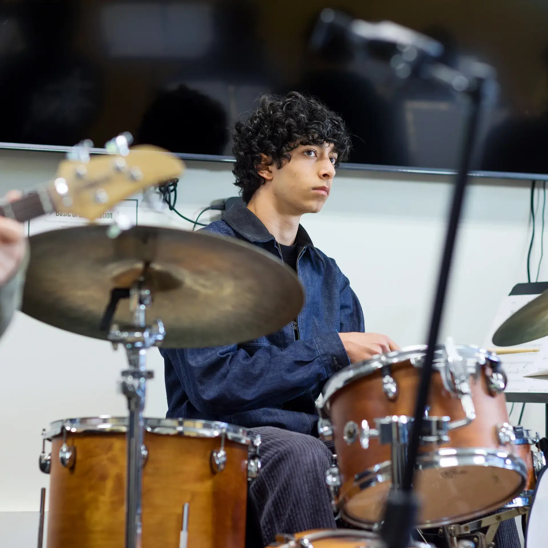 Student sitting at drum kit