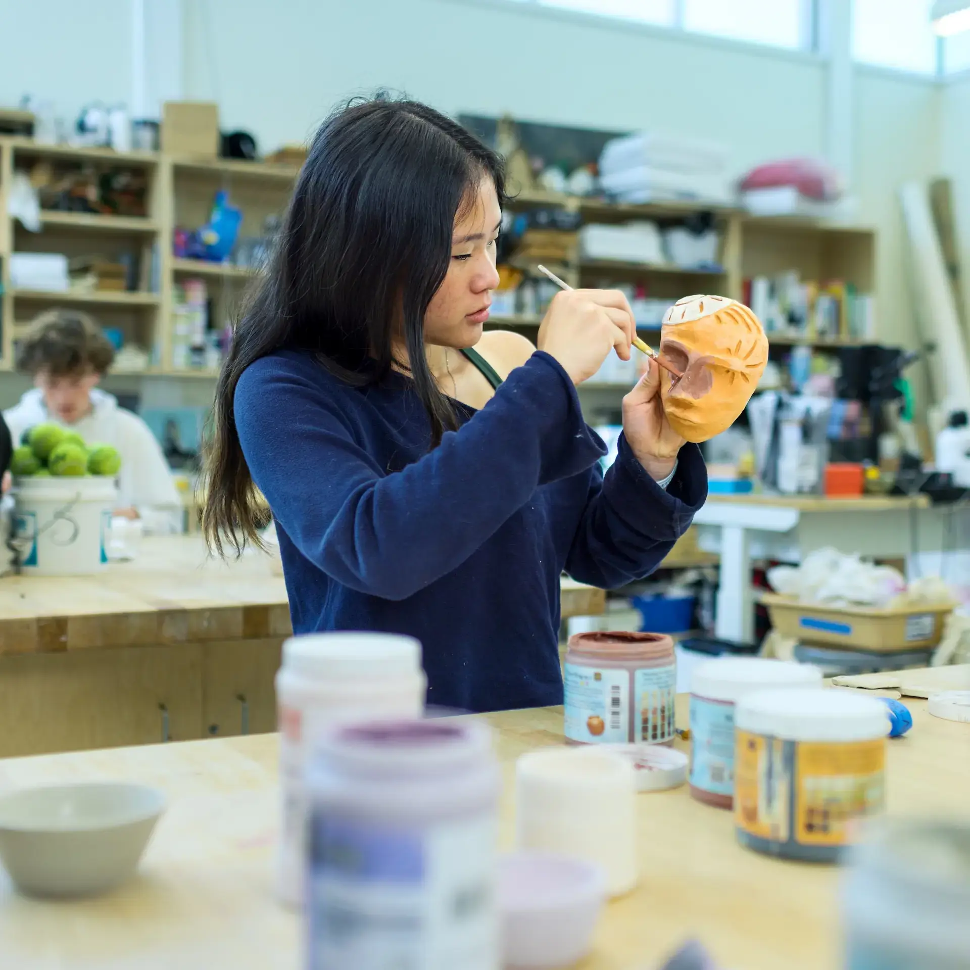Student painting sculpture